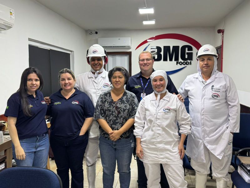 BMG Foods team presenting vacuum-packed frozen beef cuts under the BMG Foods sign